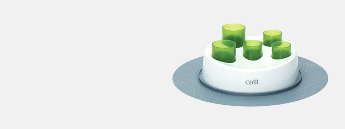 Catit Senses 2.0 Digger, a cat puzzle feeder with green tubes on a white base and grey mat
