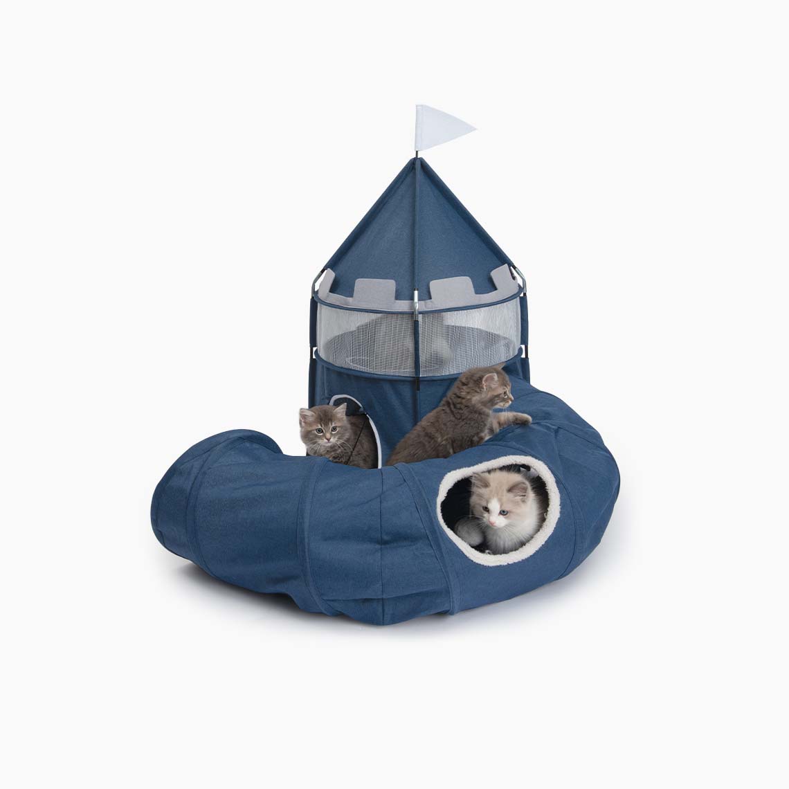 Three kittens playing in and around a blue fabric cat castle with an attached tunnel on a white background