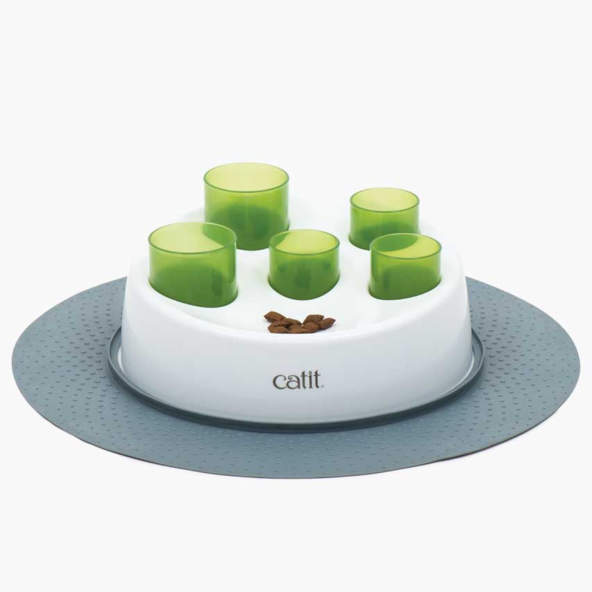 Cat treat toy with stable base with sloped surface