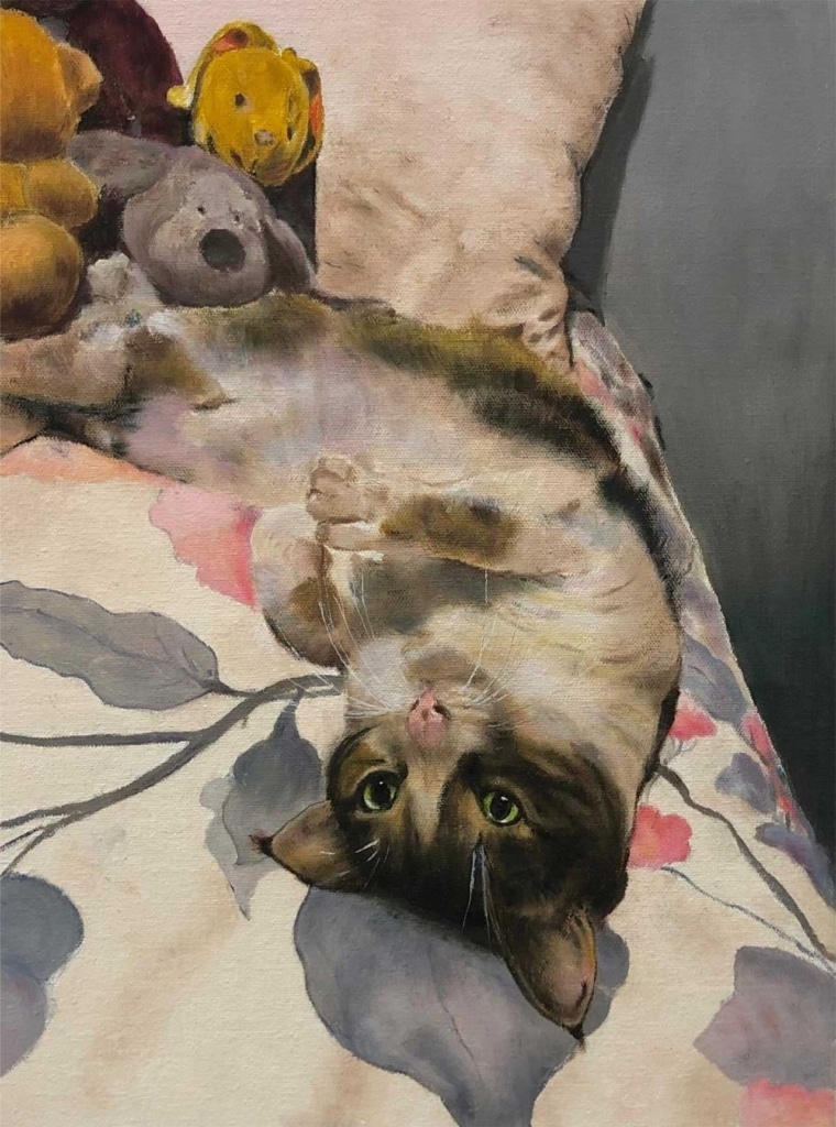 An oil painting of a cat lying on its back on a floral patterned surface near some stuffed toys