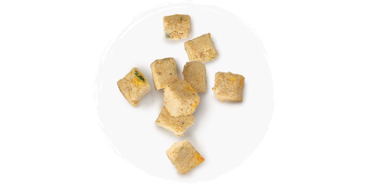 Freeze-dried whitefish cat treat cubes on a white background