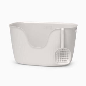 White Catit litter box with a matching scoop hanging on the side