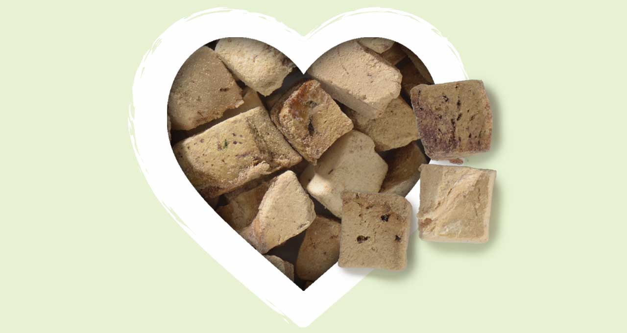Freeze-dried chicken and duck liver cat treat cubes inside a heart-shaped frame
