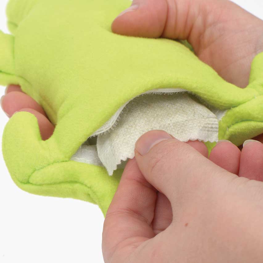 Hands opening a green gecko-shaped cat toy to insert a catnip pouch
