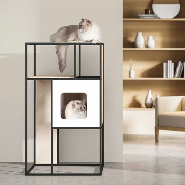 A modern, minimalist black metal cat tower with a white enclosed cubby and a scratching panel, featuring a cat resting on top and another inside