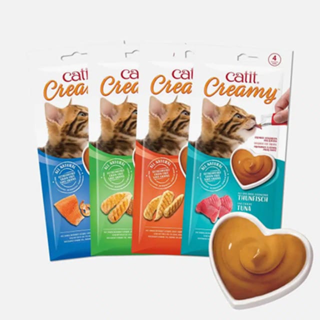 Catit Creamy cat treat tubes in four flavors with a heart-shaped bowl of creamy treat in the foreground