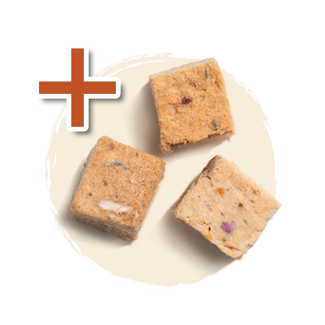 Three freeze-dried cat treat cubes on a light circular background with a plus sign icon