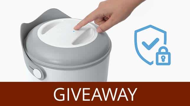 A hand pressing the button on a Catit smart cat litter box, accompanied by a security icon and the word GIVEAWAY