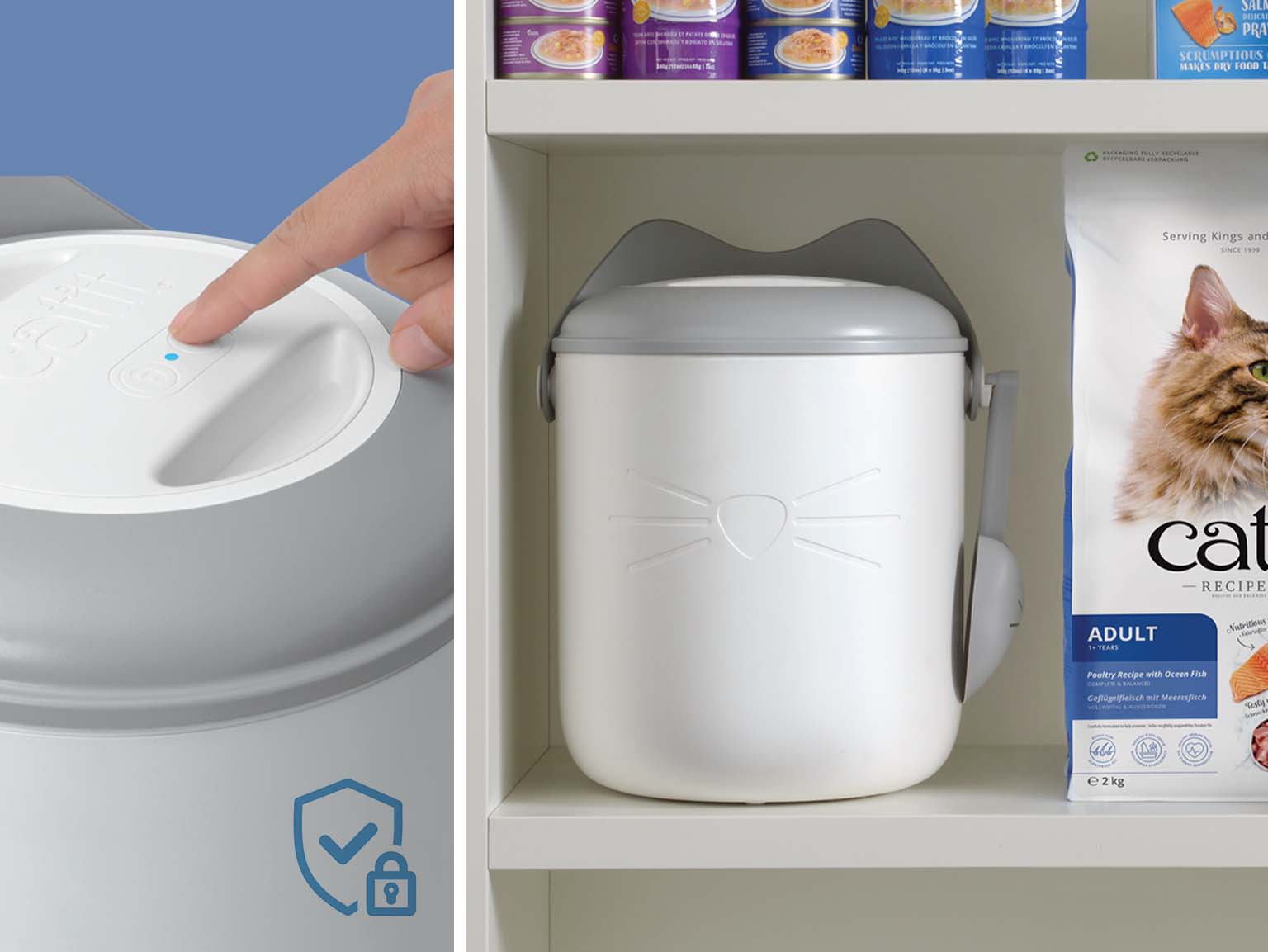 A hand presses the button on a white, cat-shaped vacuum food container, with a security lock icon indicating its sealed feature
