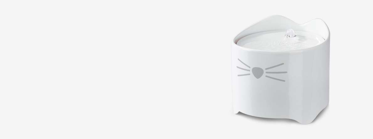 White ceramic PIXI cat water fountain with a cat face design