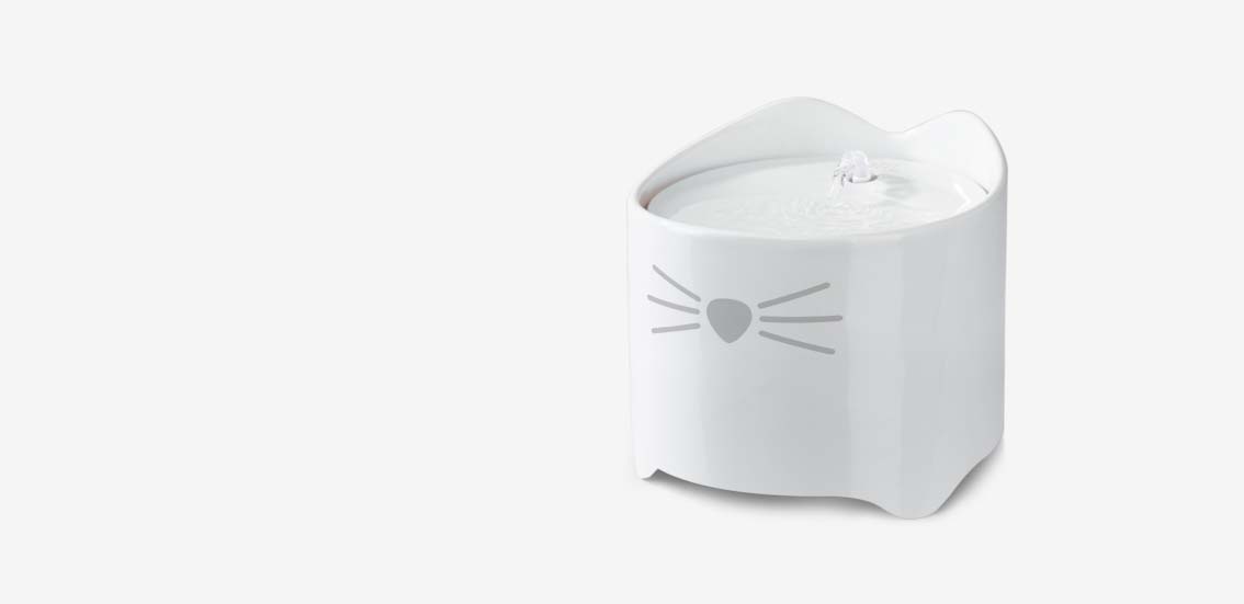 White ceramic PIXI cat water fountain with a cat face design