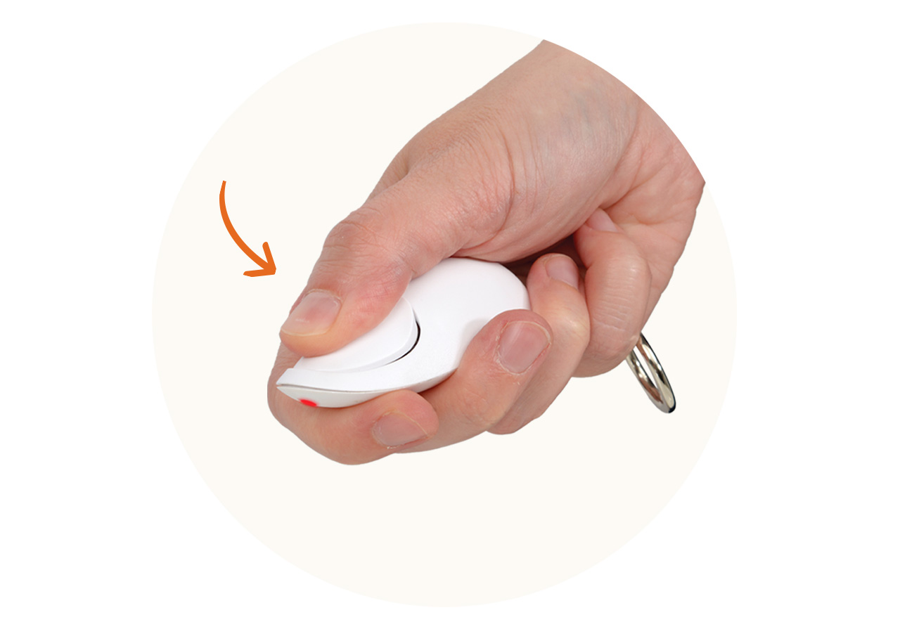 A hand holding a white laser pointer toy for cats with an orange arrow pointing to the button