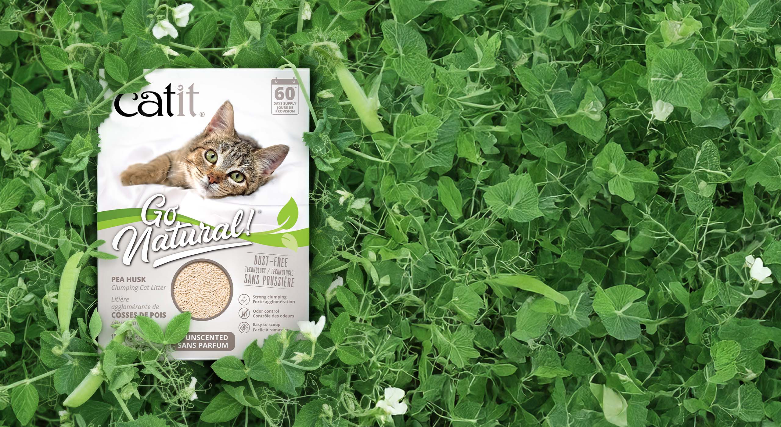 Catit Go Natural pea husk clumping cat litter packaging placed in a patch of pea plants