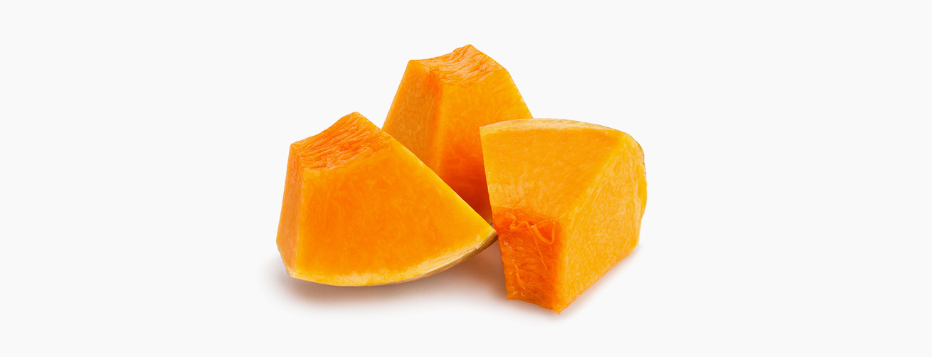 Three chunks of raw, bright orange pumpkin isolated on a white background
