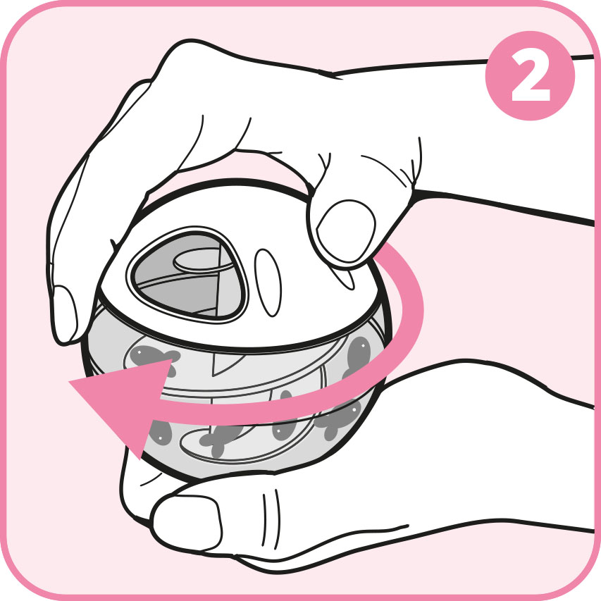 Hands twisting the top and bottom halves of a spherical cat treat toy in opposite directions to open it