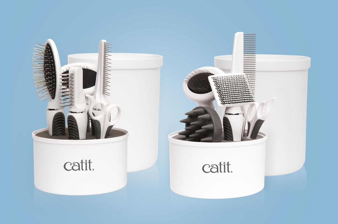 Two Catit grooming kits for longhair and shorthair cats, each containing various brushes, combs, and scissors in a container