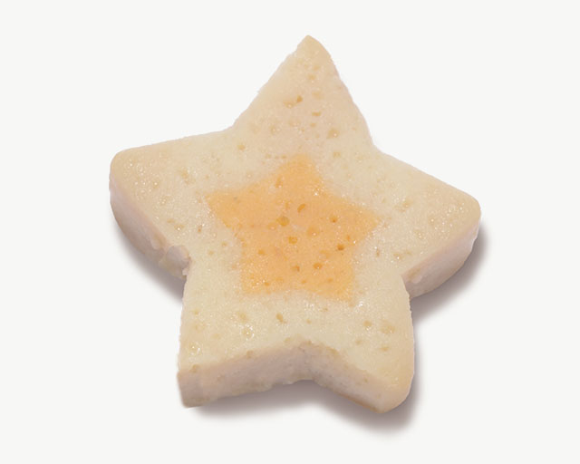 Star-shaped cat treat with a light-colored outer layer and a soft, orange-colored center
