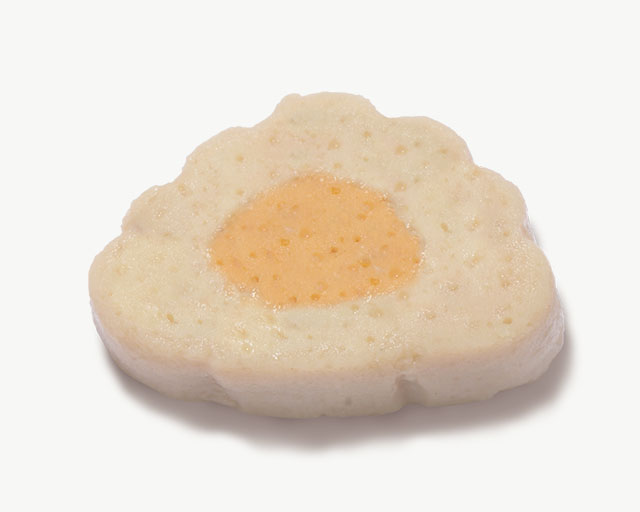 A cloud-shaped cat treat with a light-colored outer layer and an orange center