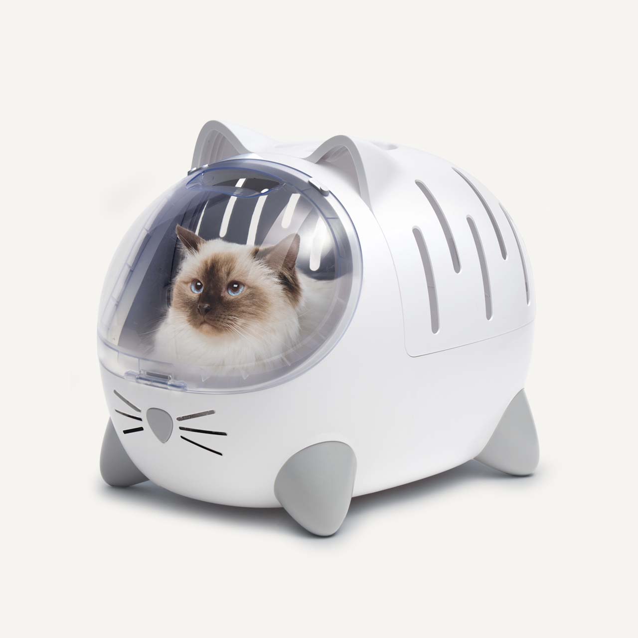 A white, cat-shaped PIXI pet carrier with a clear bubble window containing a fluffy cat inside