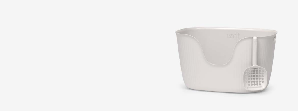 White Catit litter box with a matching scoop attached to the side