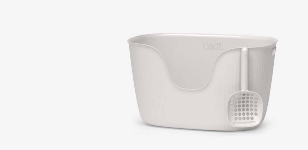White Catit litter box with a matching scoop attached to the side