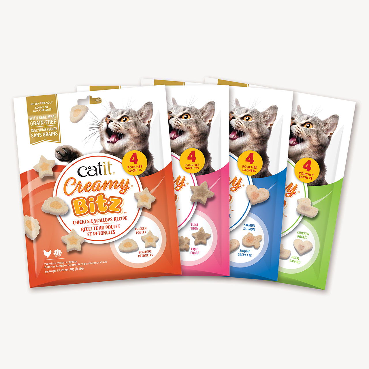 Four packages of Catit Creamy Bitz moist cat treats in various flavors, including chicken and scallops, tuna and crab, salmon and shrimp, and chicken and duck