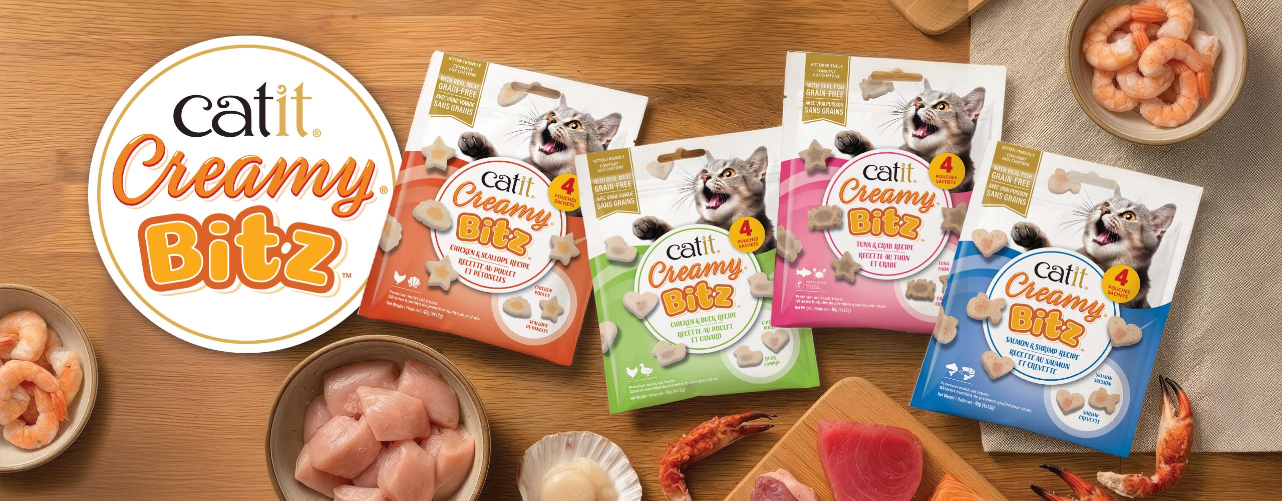 Four packages of Catit Creamy Bitz cat treats in Chicken & Scallop, Chicken & Duck, Tuna & Crab, and Salmon & Shrimp flavors