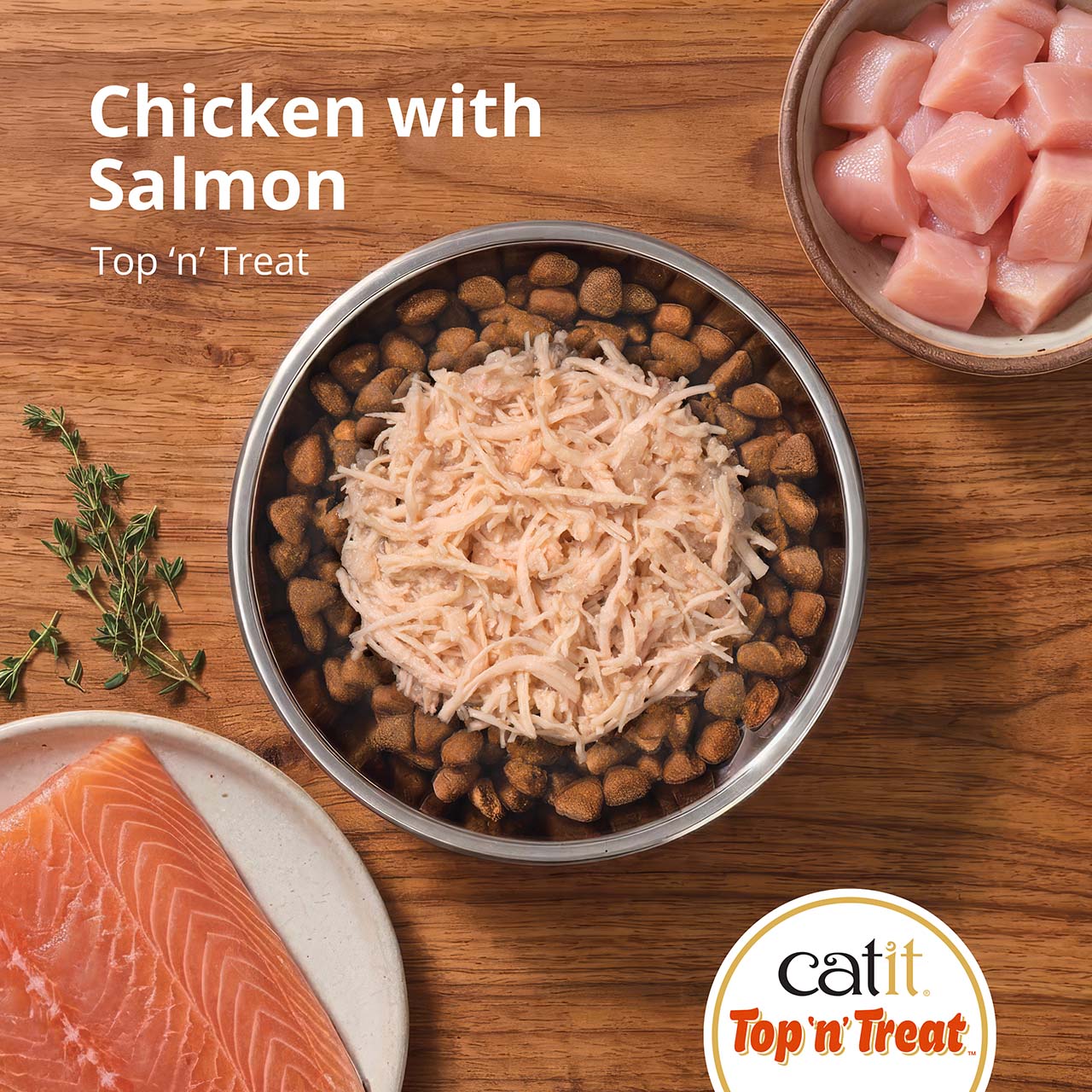 Catit Top 'n' Treat chicken with salmon cat food topper served in a bowl with raw chicken and salmon ingredients