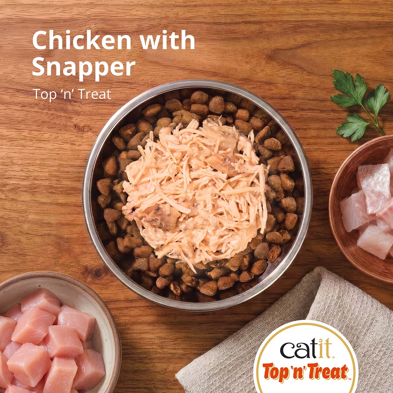 Catit Top 'n' Treat advertisement featuring a bowl of dry cat food topped with shredded chicken and snapper