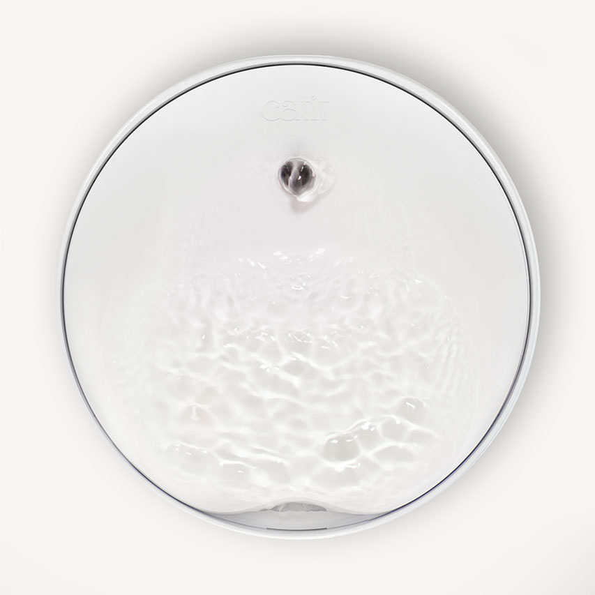 Top-down view of a white Catit PIXI Mini fountain with water flowing over the surface