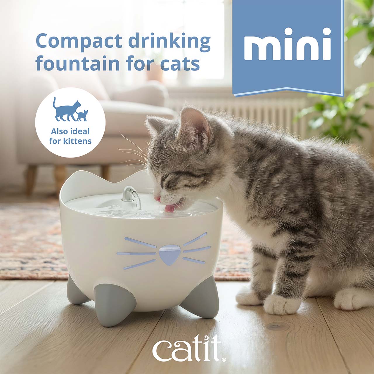 A kitten drinking from a white Catit PIXI mini cat water fountain shaped like a cat face