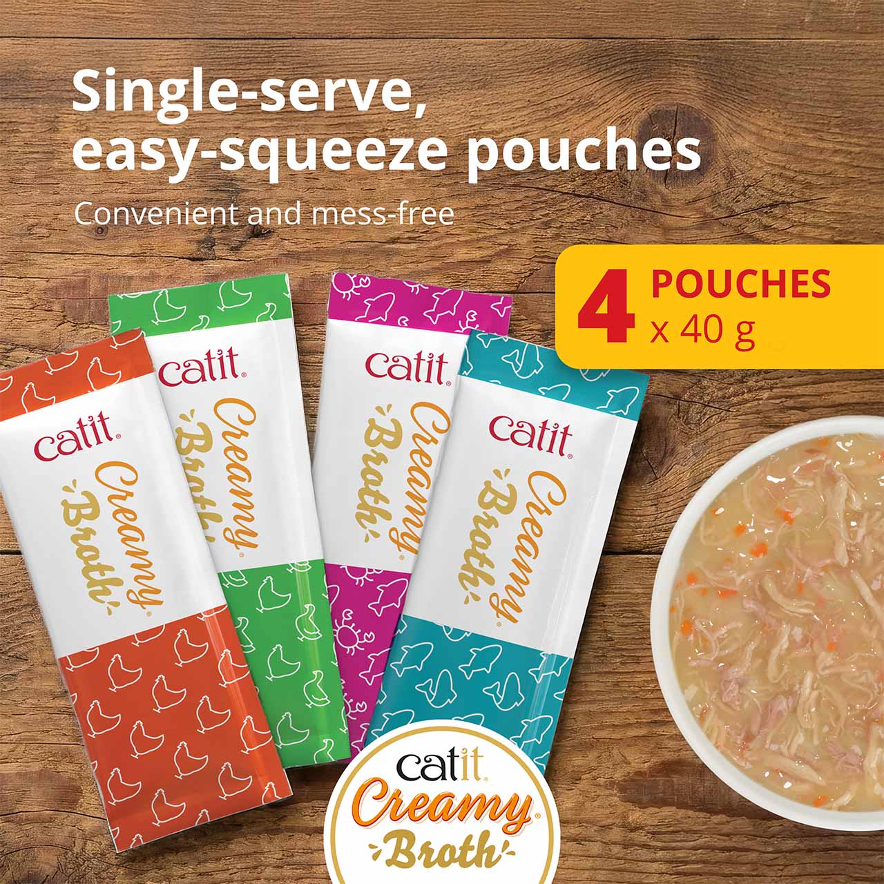 Catit Creamy Broth cat treats in four single-serve, easy-squeeze pouches with a bowl of broth shown on the side