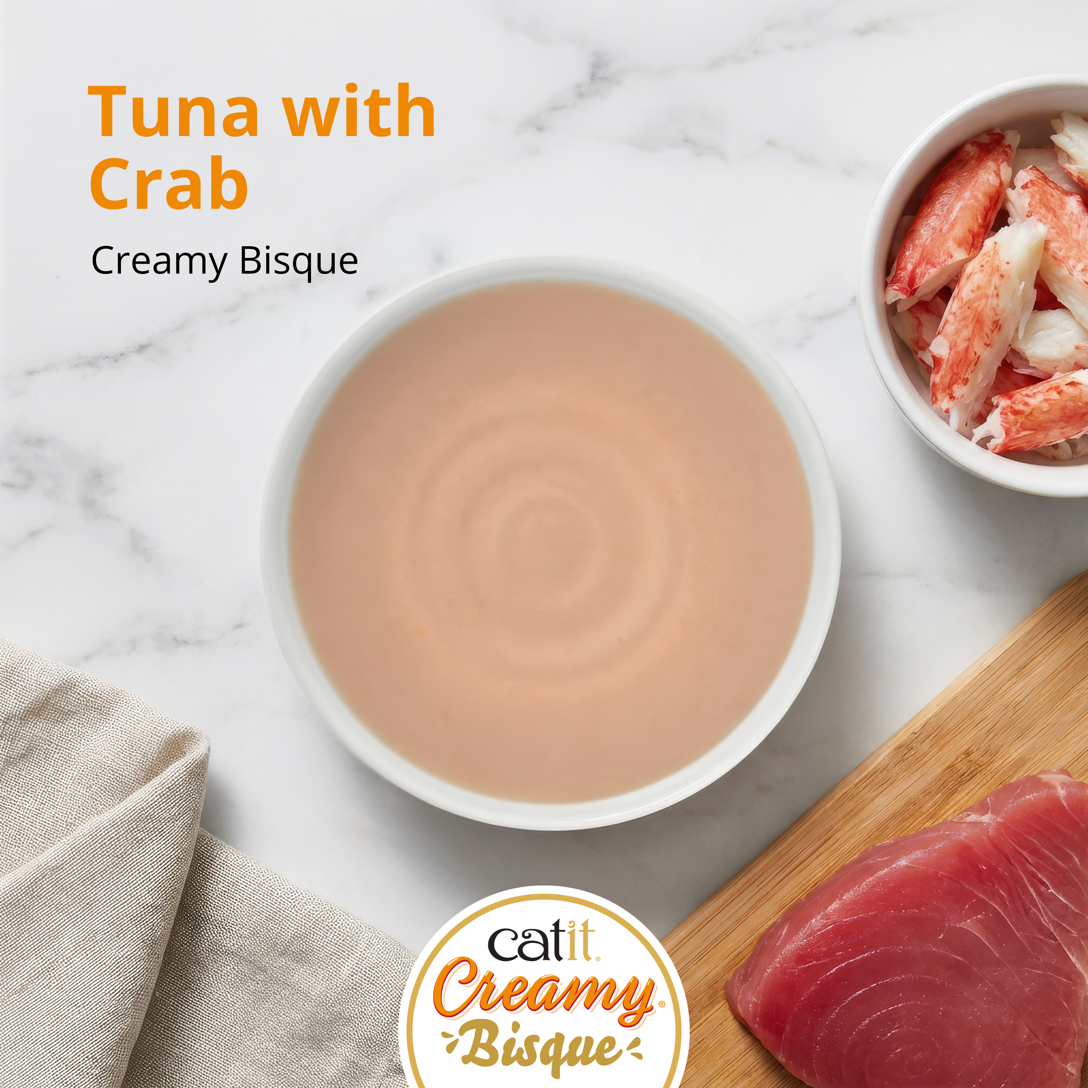 Catit Creamy Bisque cat treat in Tuna with Crab flavor, featuring a bowl of bisque, crab meat, and a tuna fillet