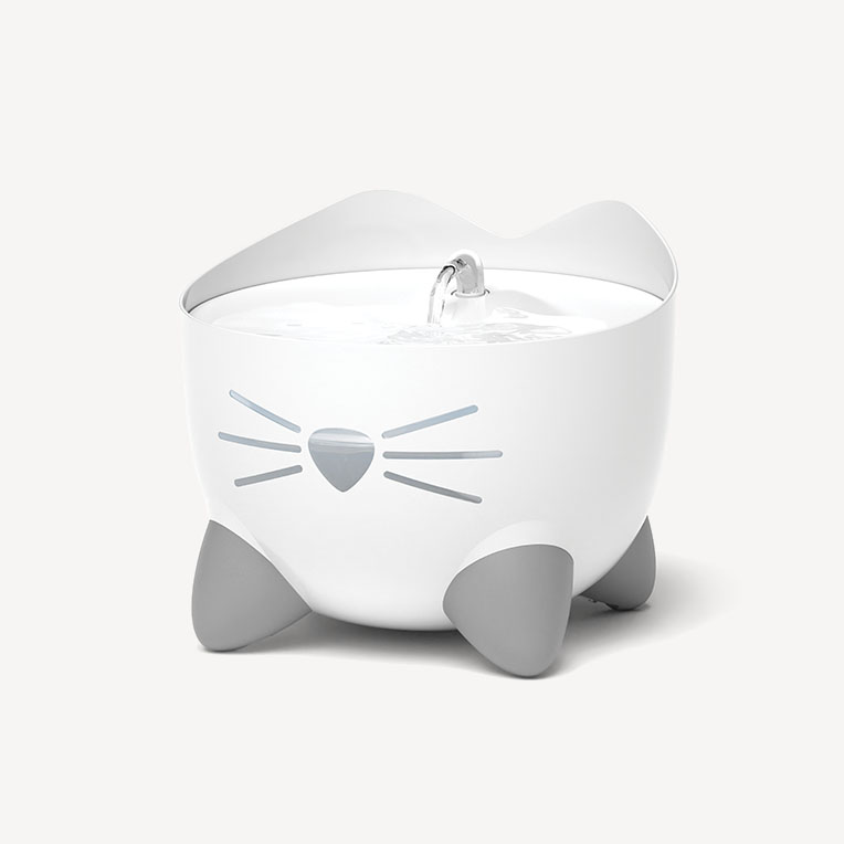White cat-shaped PIXI water fountain with gray feet and a small water spout on a plain background