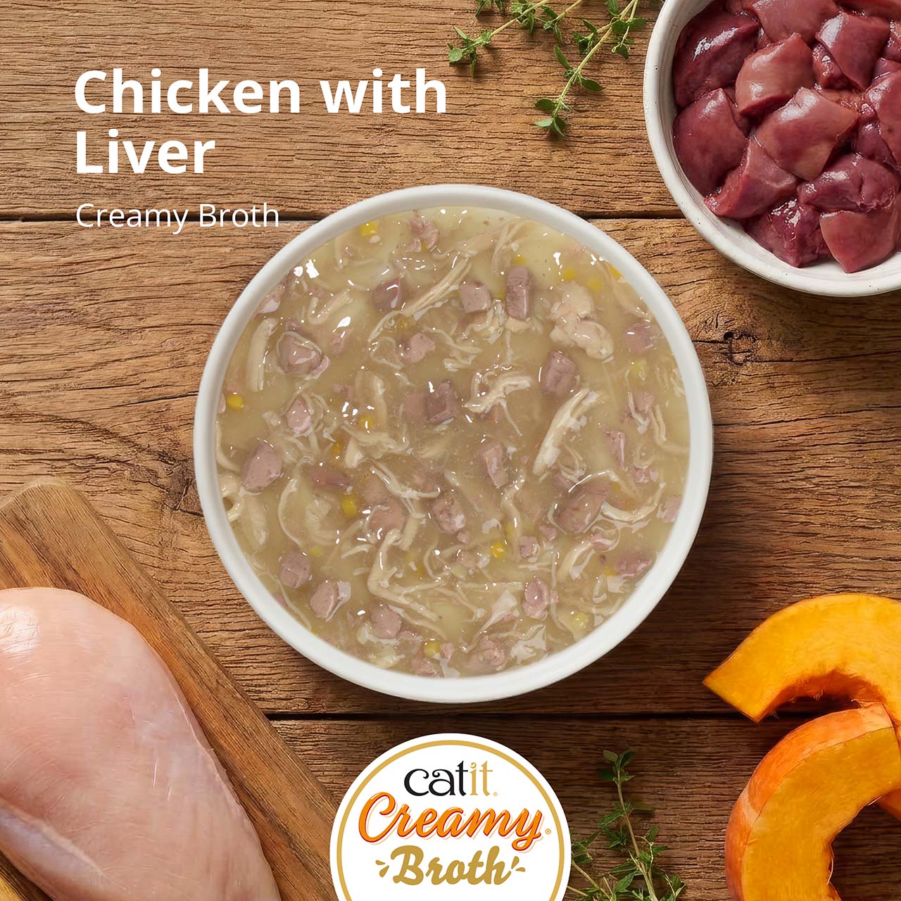 Catit Creamy Broth cat food in a bowl, featuring chicken and liver with ingredients like pumpkin and herbs on a wooden table