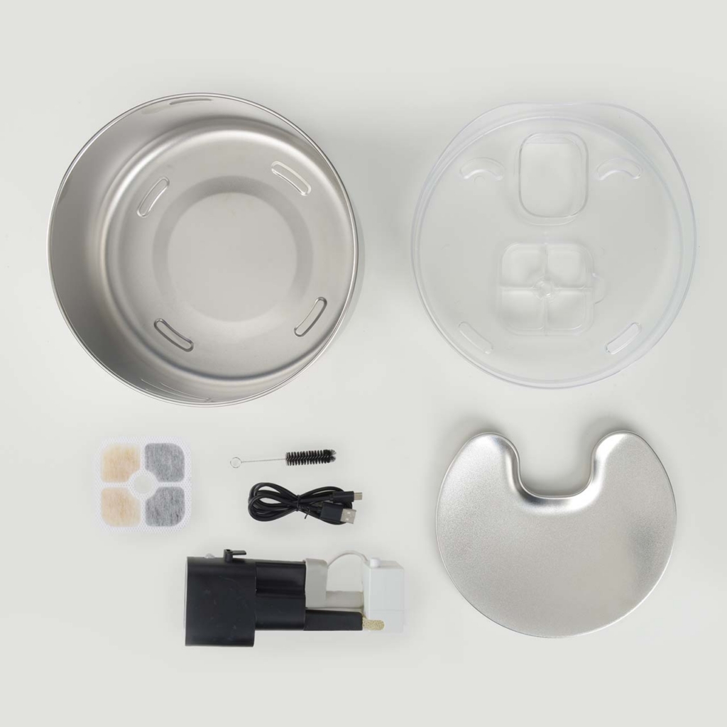 Components of a Catit PIXI stainless steel cat water fountain, including the basin, lid, pump, filter, and cleaning brush