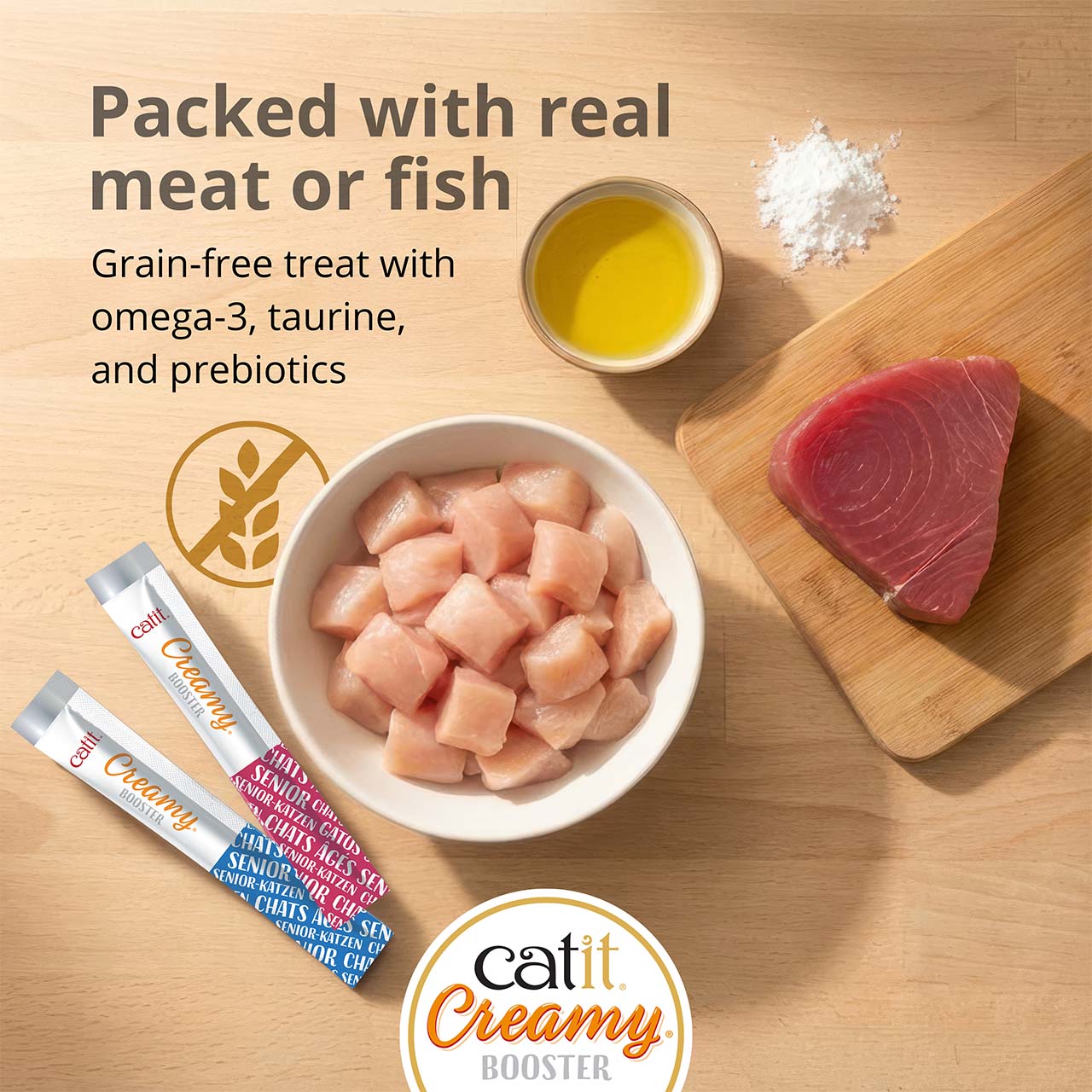 Catit Creamy Booster senior cat treat advertisement highlighting real meat or fish, grain-free ingredients, and added nutrients