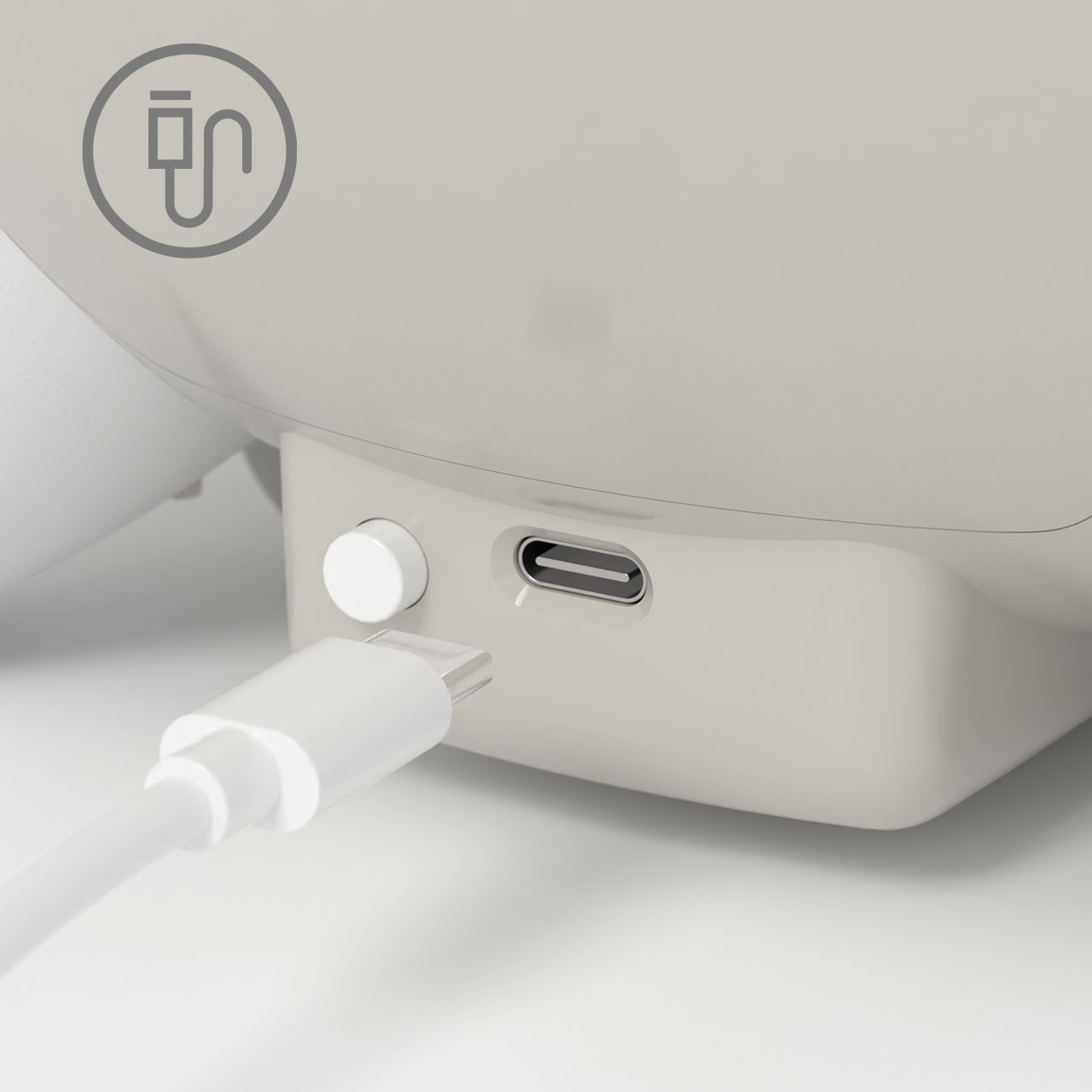 Close-up of a Catit PIXI fountain base showing a USB-C charging port and a power button with a charging cable nearby
