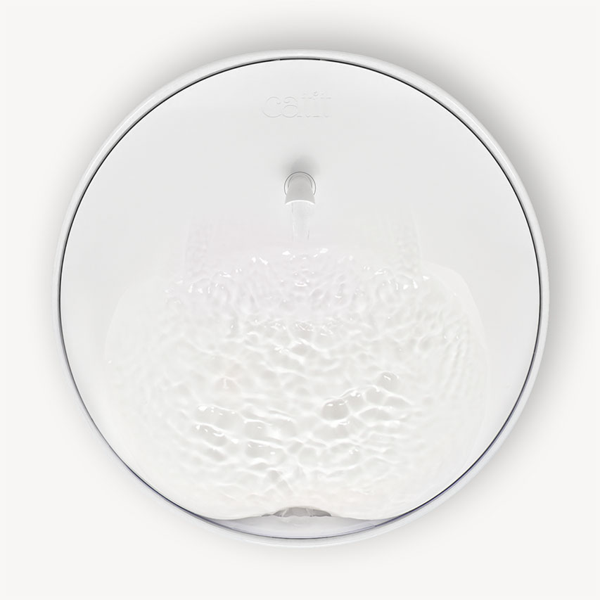 Top-down view of a white Catit PIXI water fountain with flowing water in the basin