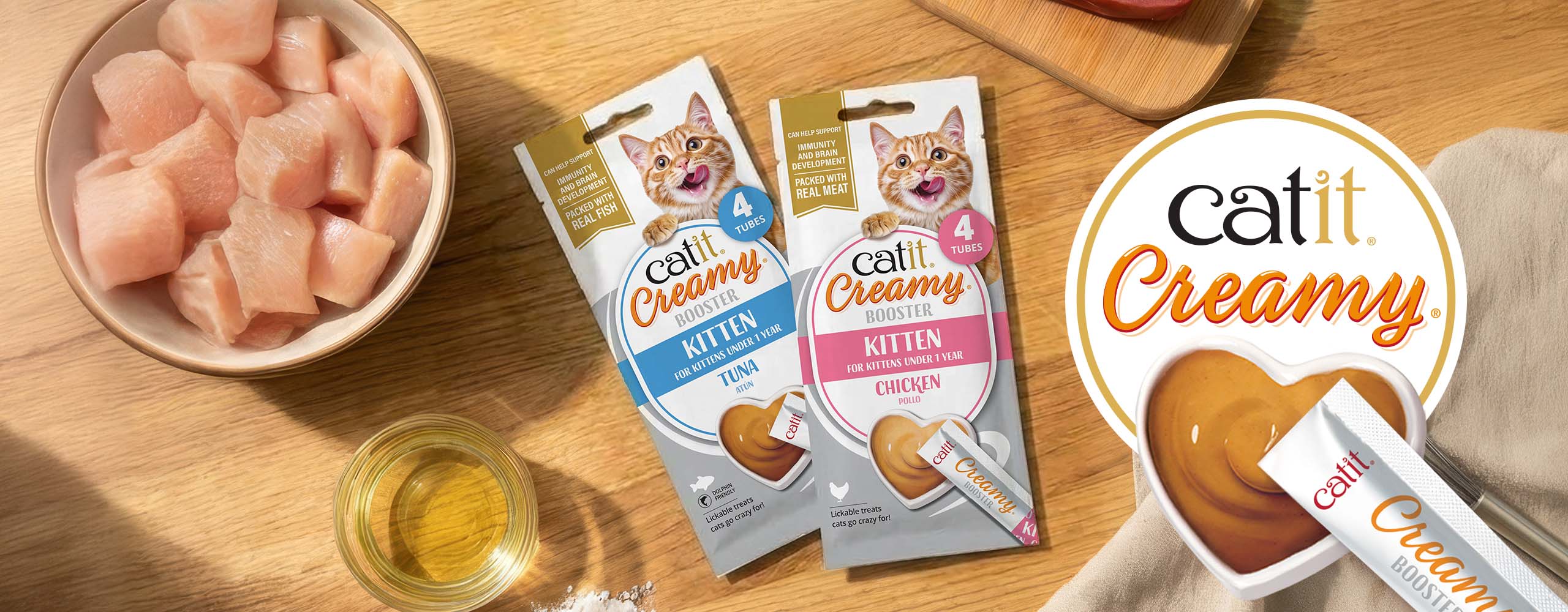 Catit Creamy Booster lickable treats for kittens in tuna and chicken flavors, featuring real meat and immunity support