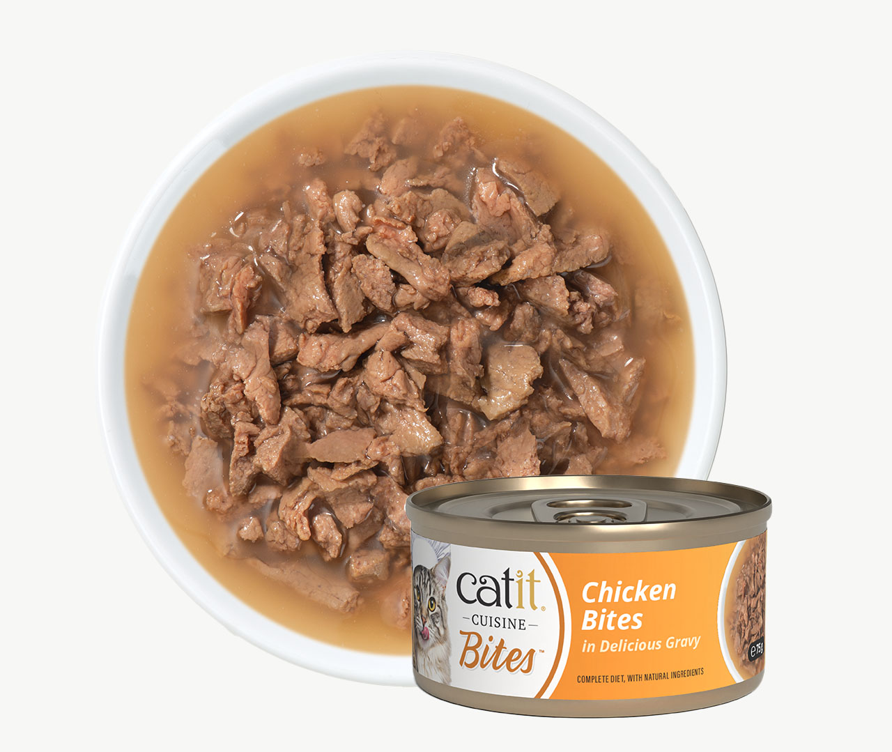 A bowl of Catit Cuisine Chicken Bites cat food in gravy next to its product packaging