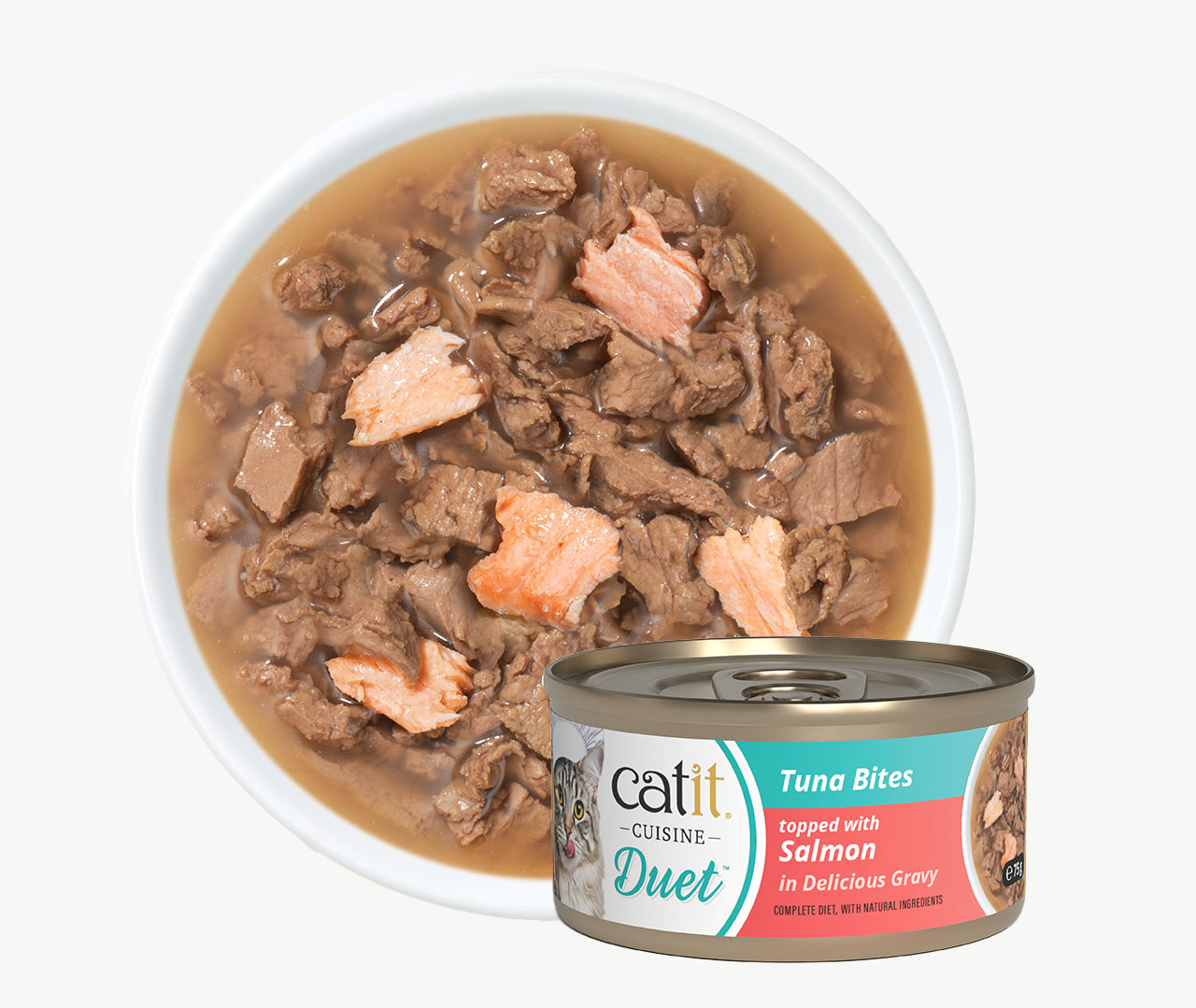 A bowl of wet cat food with tuna and salmon chunks in gravy next to a can of Catit Cuisine Duet Tuna Bites with Salmon