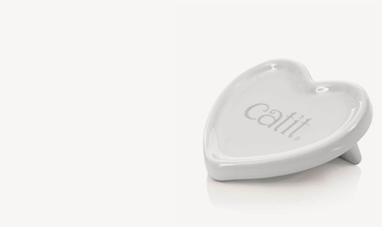 White ceramic heart-shaped dish with the Catit logo embossed in the center