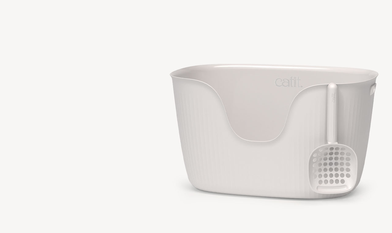 White Catit litter box with a matching scoop attached to the side