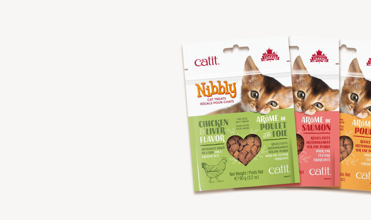 Three packages of Catit Nibbly cat treats in chicken and liver, salmon, and poultry flavors