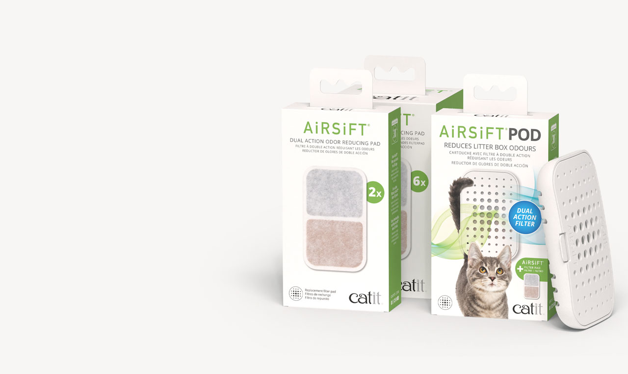 Catit Airsift litter box odor reducing pads and pod packaging with a cat pictured on the pod packaging