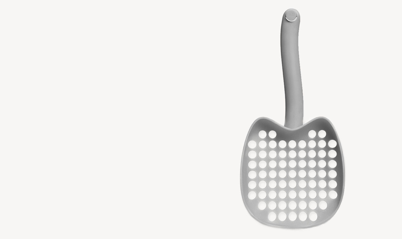 Grey PIXI cat litter scoop with a perforated head and curved handle