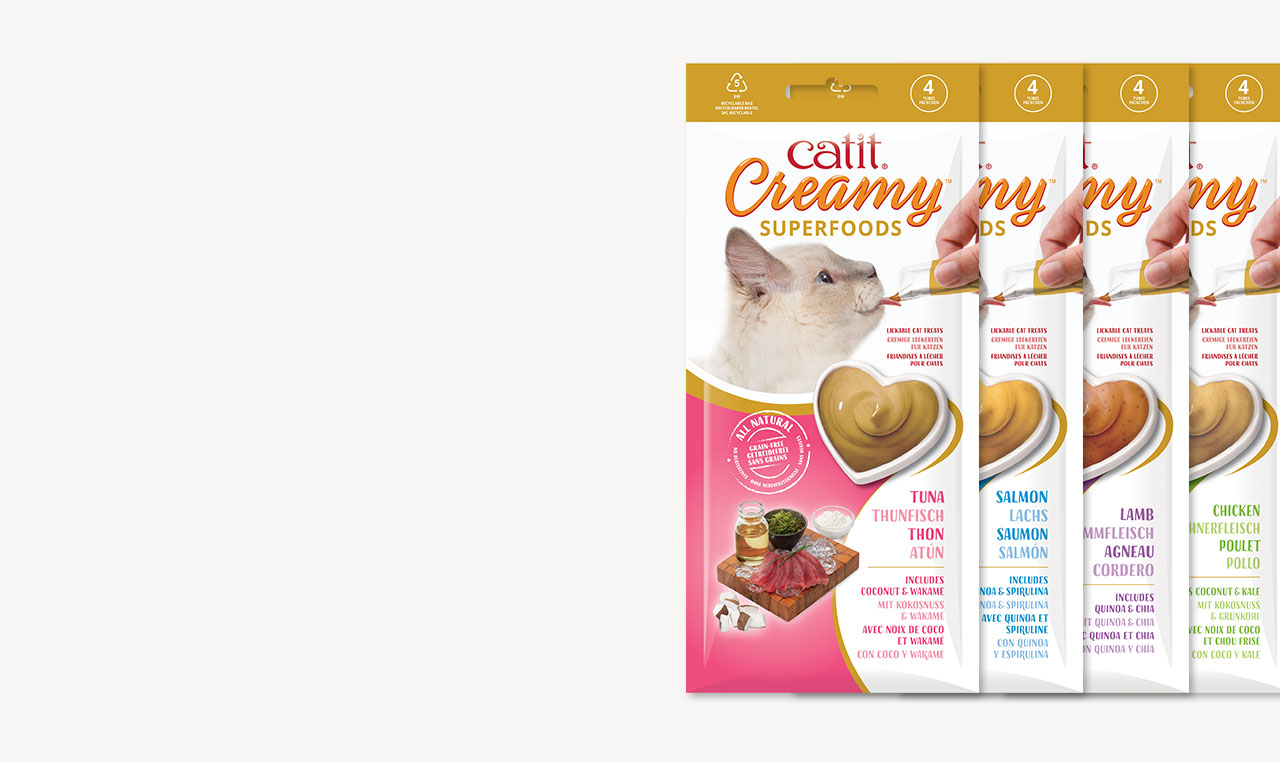 Four packages of Catit Creamy Superfoods lickable cat treats in tuna, salmon, lamb, and chicken flavors