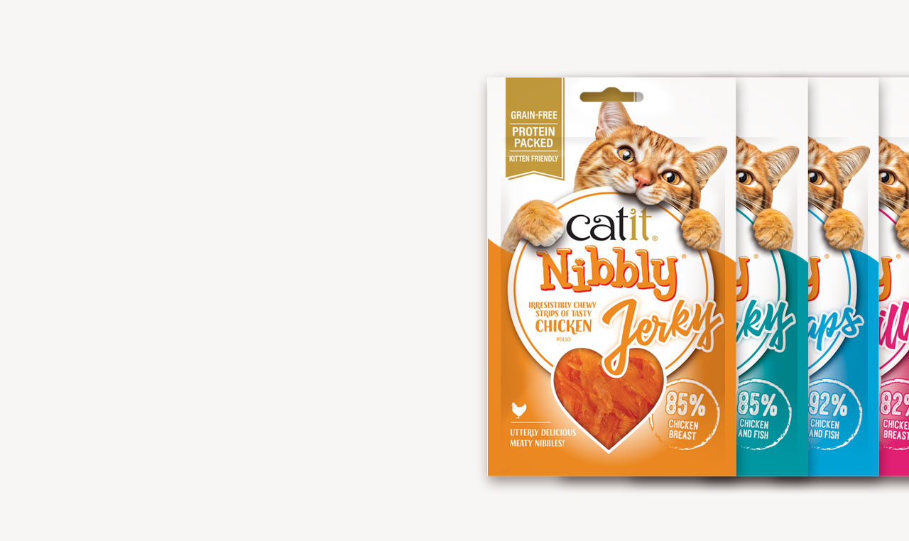Catit Nibbly Jerky cat treat packaging in various flavors featuring a cat peeking over the top