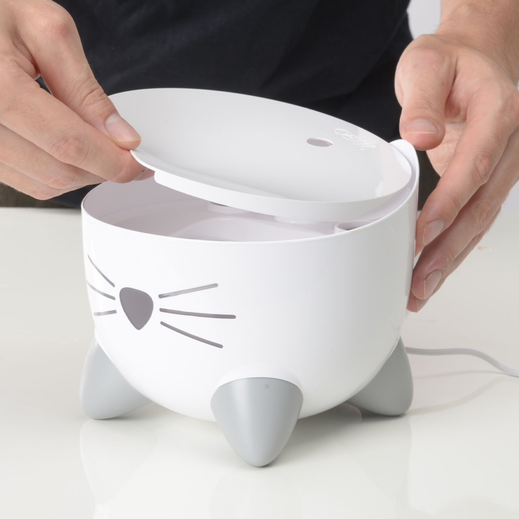 hands placing top on the PIXI Mini Fountain